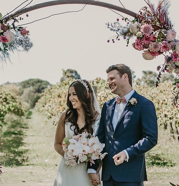 Wedding couple under a blsuh circle arbour at the vinegrove Mudgee, florals by mudgee monkey wedding and event florist