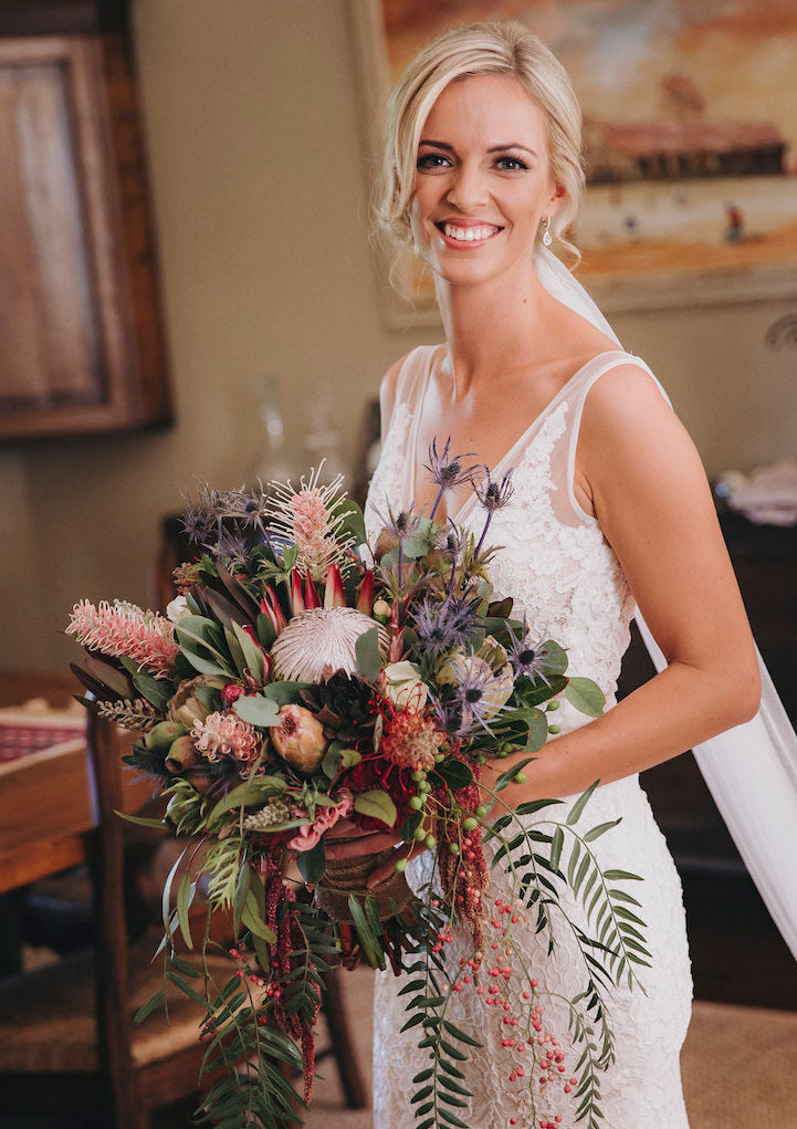 wedding bouquet featuring king protea and native blooms by mudgee monkey wedding and event florist and styling in mudgee for rustic wedding