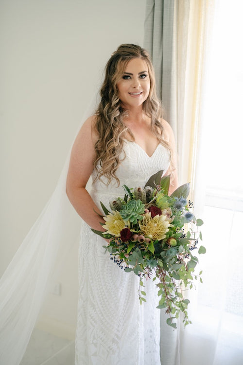 Bride in wedding dress with a native flower bouquet created by mudgee monkey florist
