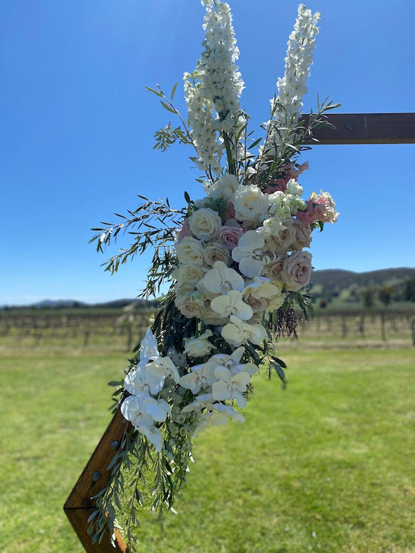 rose and orchids for this Mudgee weeding arbour. mundee monkey wedding florist