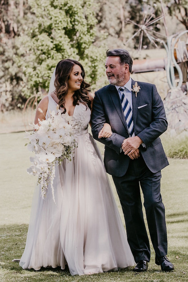 walking with Dad at this mudgee wedding with bouquet from Mudgee monkey florist